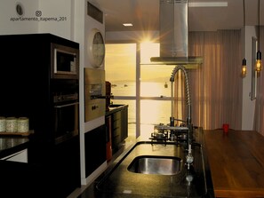 Deluxe Apartment, Beach View | Private kitchen | Fridge, cookware/dishes/utensils, dining tables