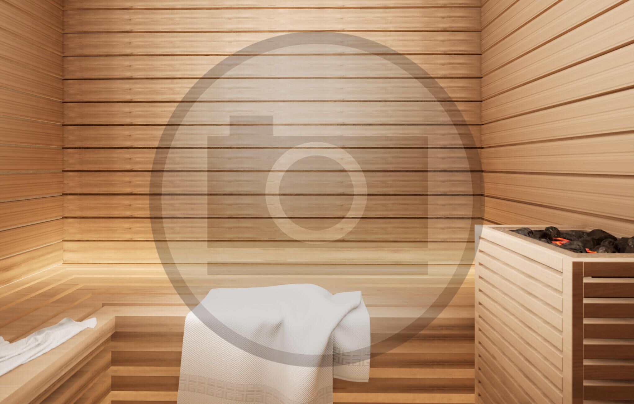 A sauna room with wooden slats on the walls and a bench with a towel.