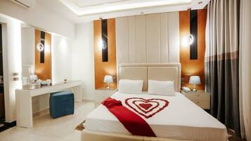 Une chambre d’hôtel avec un grand lit, un bureau et un miroir.