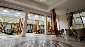 A spacious lobby with a central circular floor design, a large chandelier, and multiple seating areas. - Ramage Hotel & Resort (Cairo)