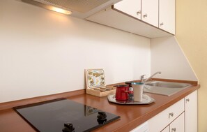 Fridge, microwave, stovetop, coffee/tea maker