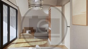 Habitació d'hotel moderna amb un gran finestral corredís, seients de sofà, una catifa estampada i un parell de tovalloles arremolinades al sòl.