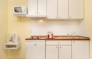 Fridge, microwave, stovetop, coffee/tea maker