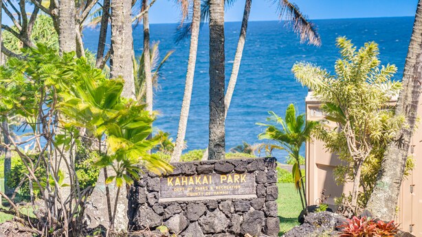 Segnaletica per il parco Kahakai con vista sull'oceano.