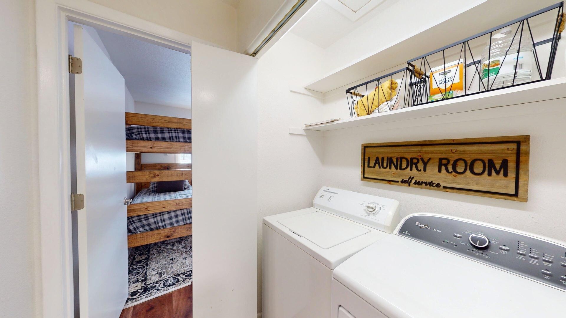 A laundry room with a sign indicating it is for self-service.