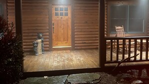 A wooden cabin with a front door, a porch, and a small seating area. - Gratitude View - It's cooler in the mountains! (Ararat)
