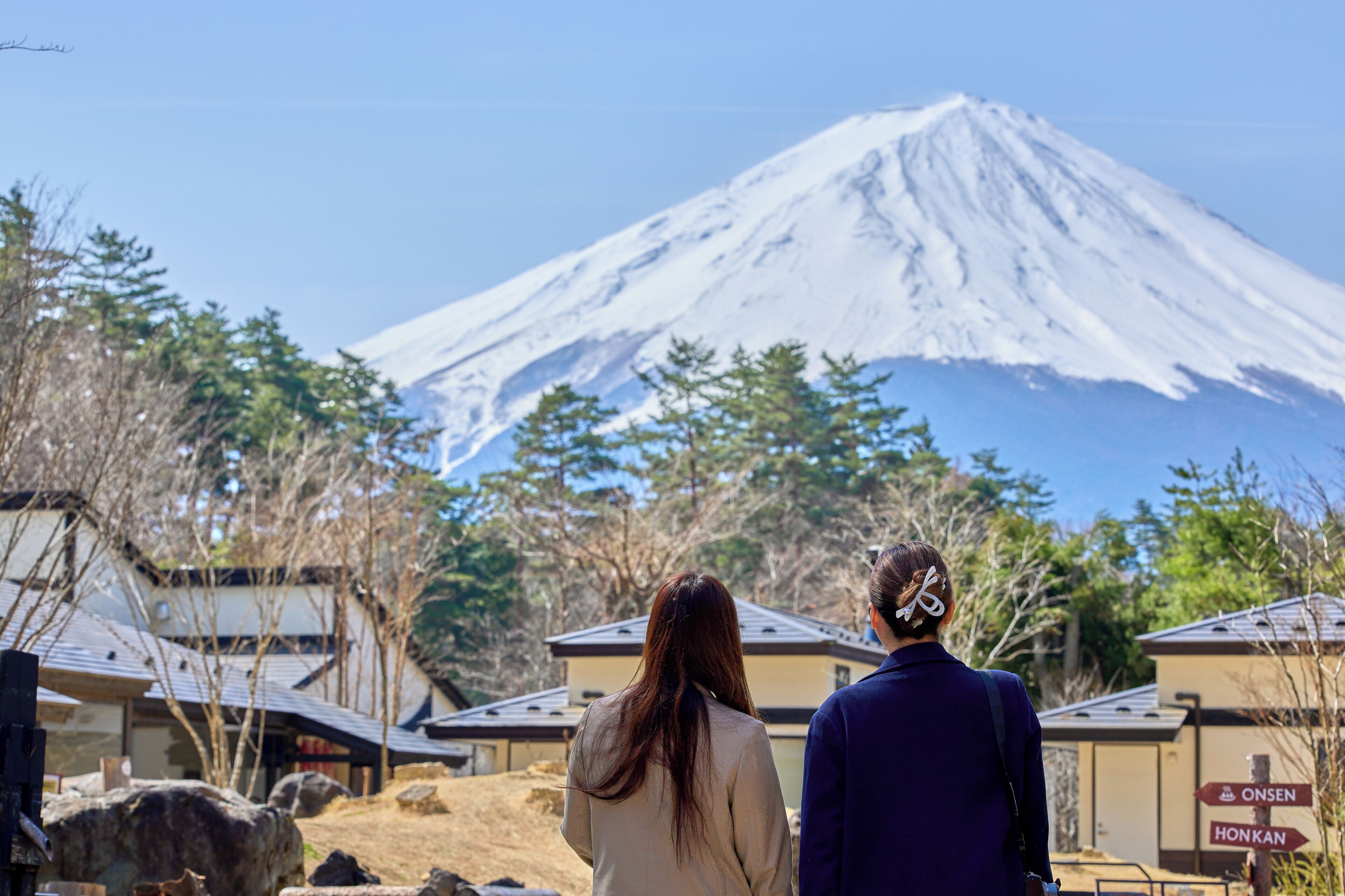 A view of Mount Fuji with two people in the foreground.