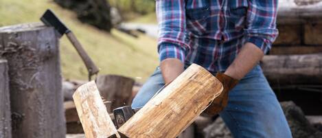 A person chopping wood with an axe.