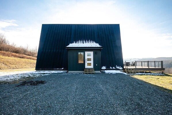 A modern building with a dark facade and a small entrance. - Modern A-Frame With Secluded Mountain Views & Fire Pit (Westfield)