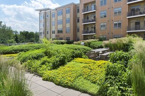 Experience a tranquil living space with balconies, lush gardens, and outdoor seating areas.
