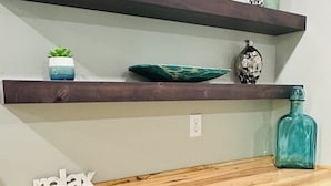 A kitchen with wooden shelves, a countertop, and a 'HOME' sign. - Located in the Heart of MN Lakes Country with much to do in the area. (Lake Park)
