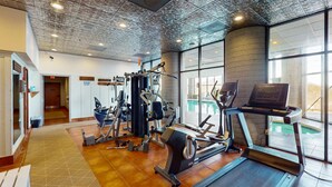 A gym with various exercise equipment, large windows, and a concrete pillar. - 8th-floor condo with mountain view, pools, hot tubs, saunas, & gym (Sugar Mountain)