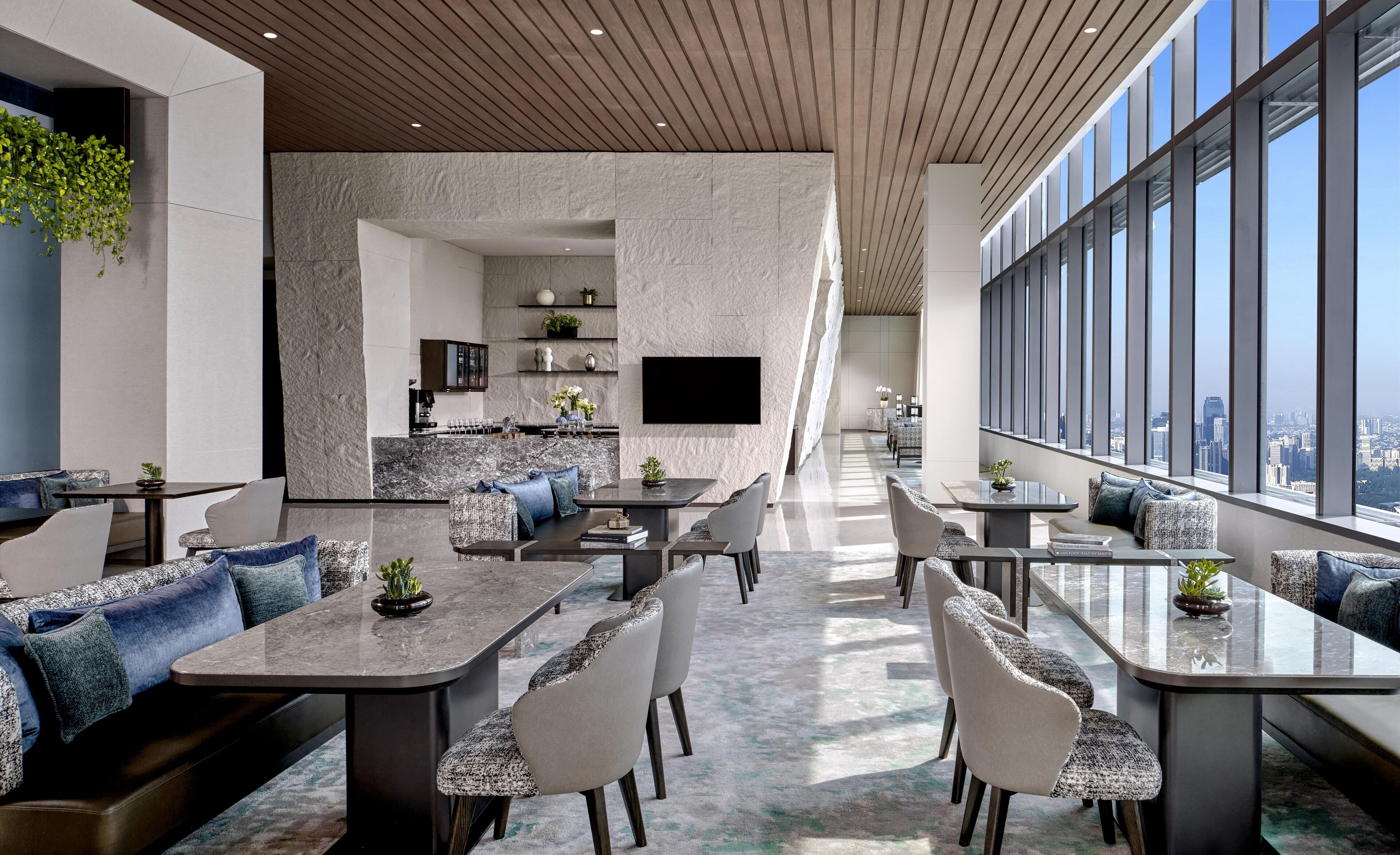 A modern interior with a dining area, seating, and a kitchen.