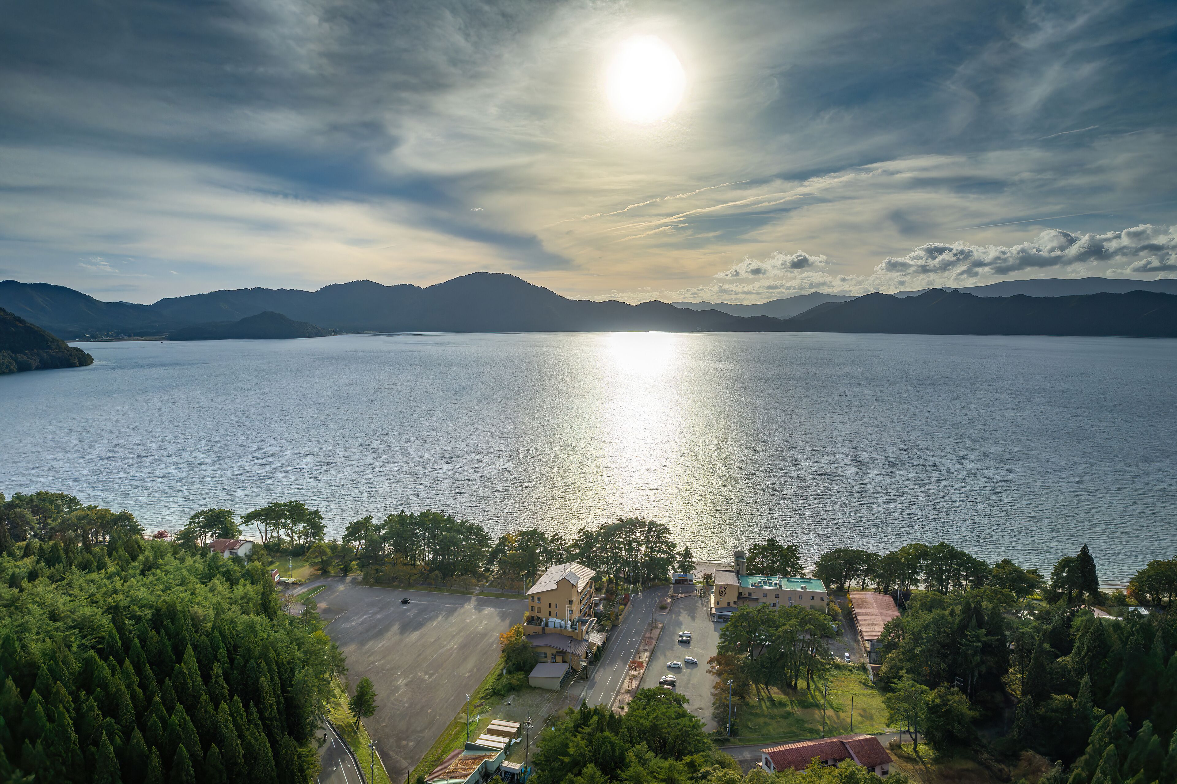 A coastal town with a view of the sea and mountains.