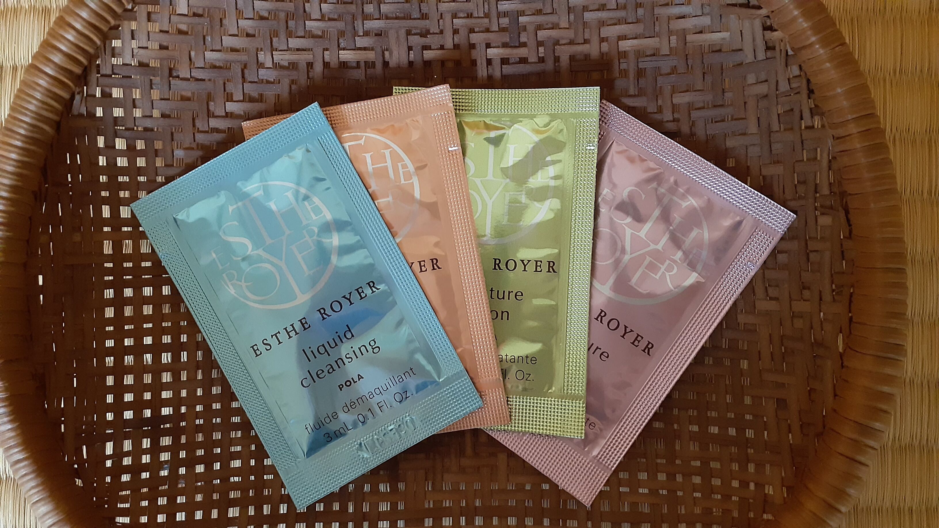 A basket containing four packets of Estée Lauder products.