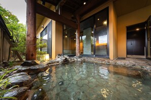 A traditional Japanese-style building with a stone water feature in front. - Kashintei Shirahama (Senboku)