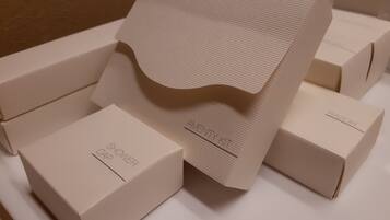 A set of neatly arranged cardboard boxes with labels, including one marked "AMENITY KIT".
