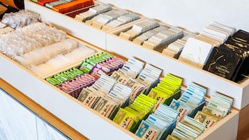 A display of various packaged goods, including food items and possibly cosmetics, arranged in a wooden drawer.