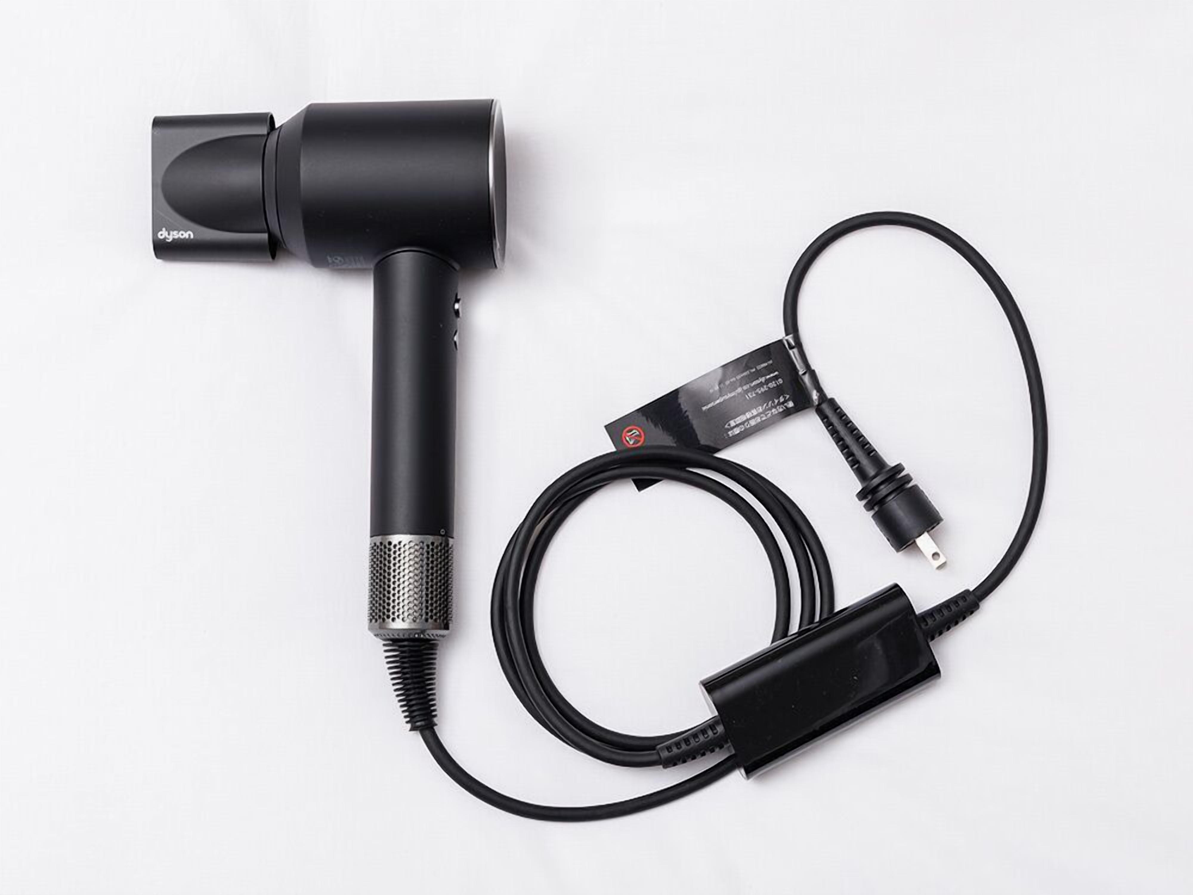 A black microphone with a cable and a power adapter.