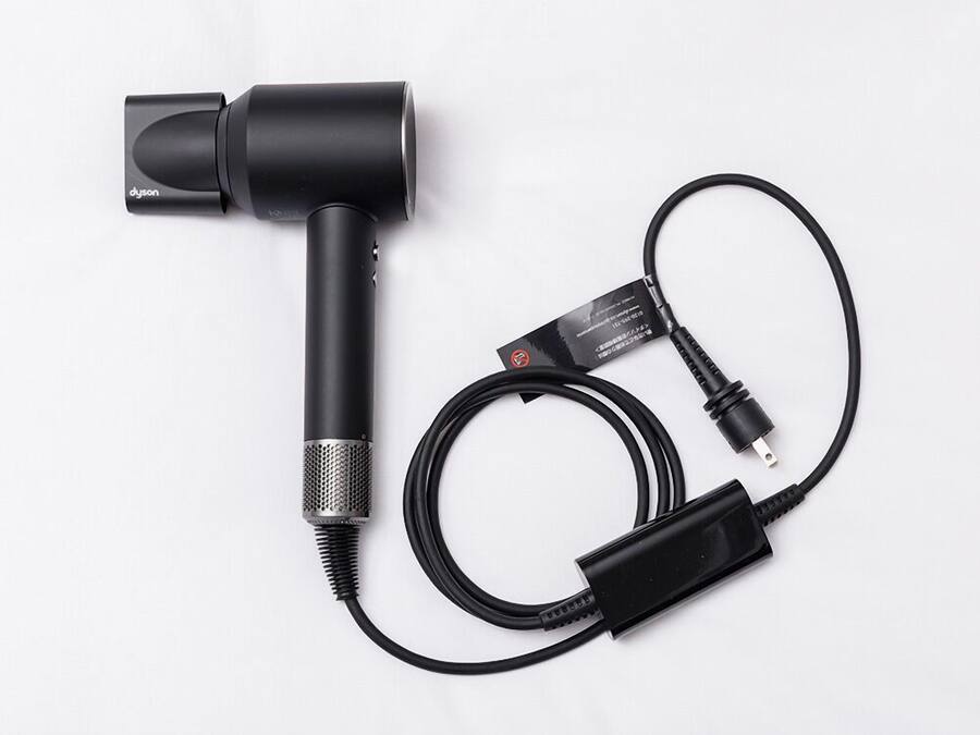 A black microphone with a cable and a power adapter.
