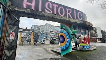 An entrance with a 'HISTORIC' sign, a mural, and a colorful kiosk.