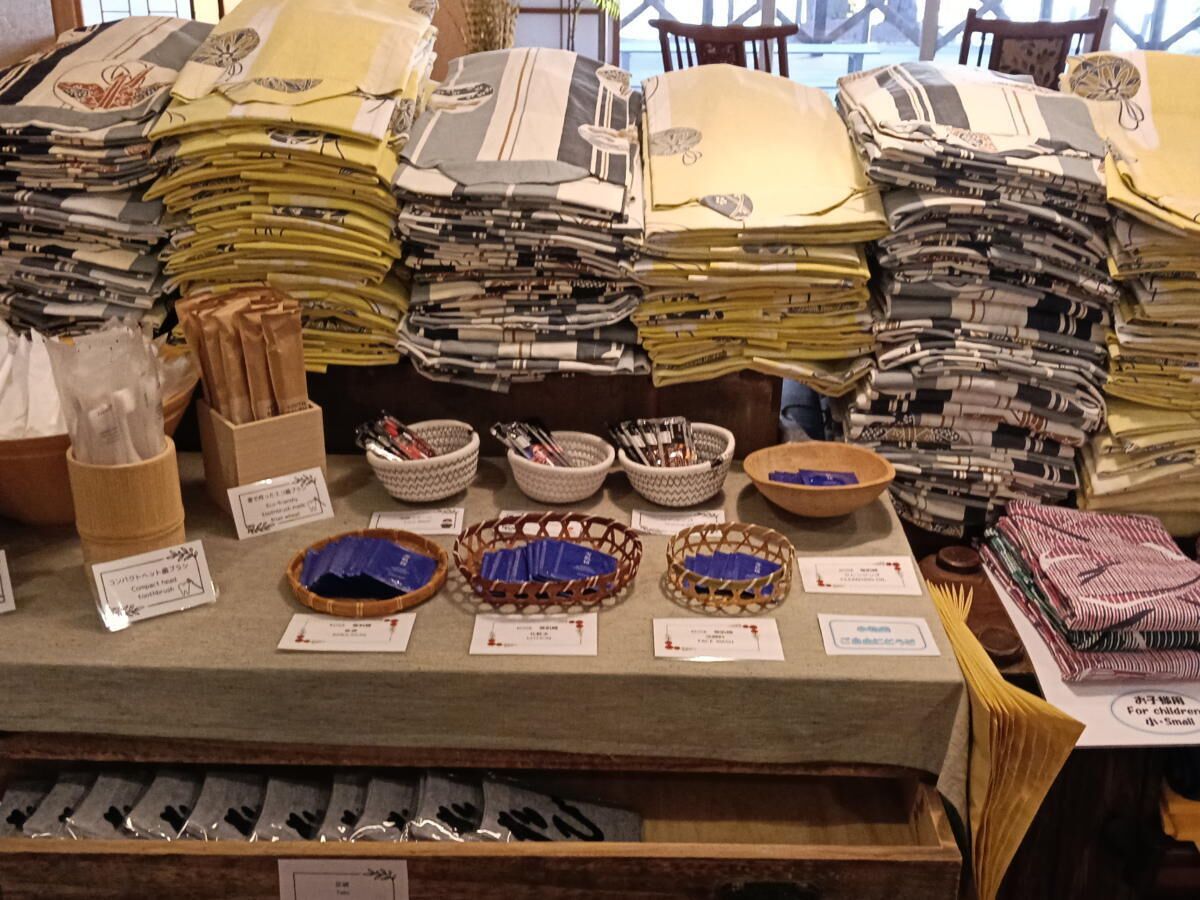 A display of folded fabrics and baskets with labels, likely in a fabric store.