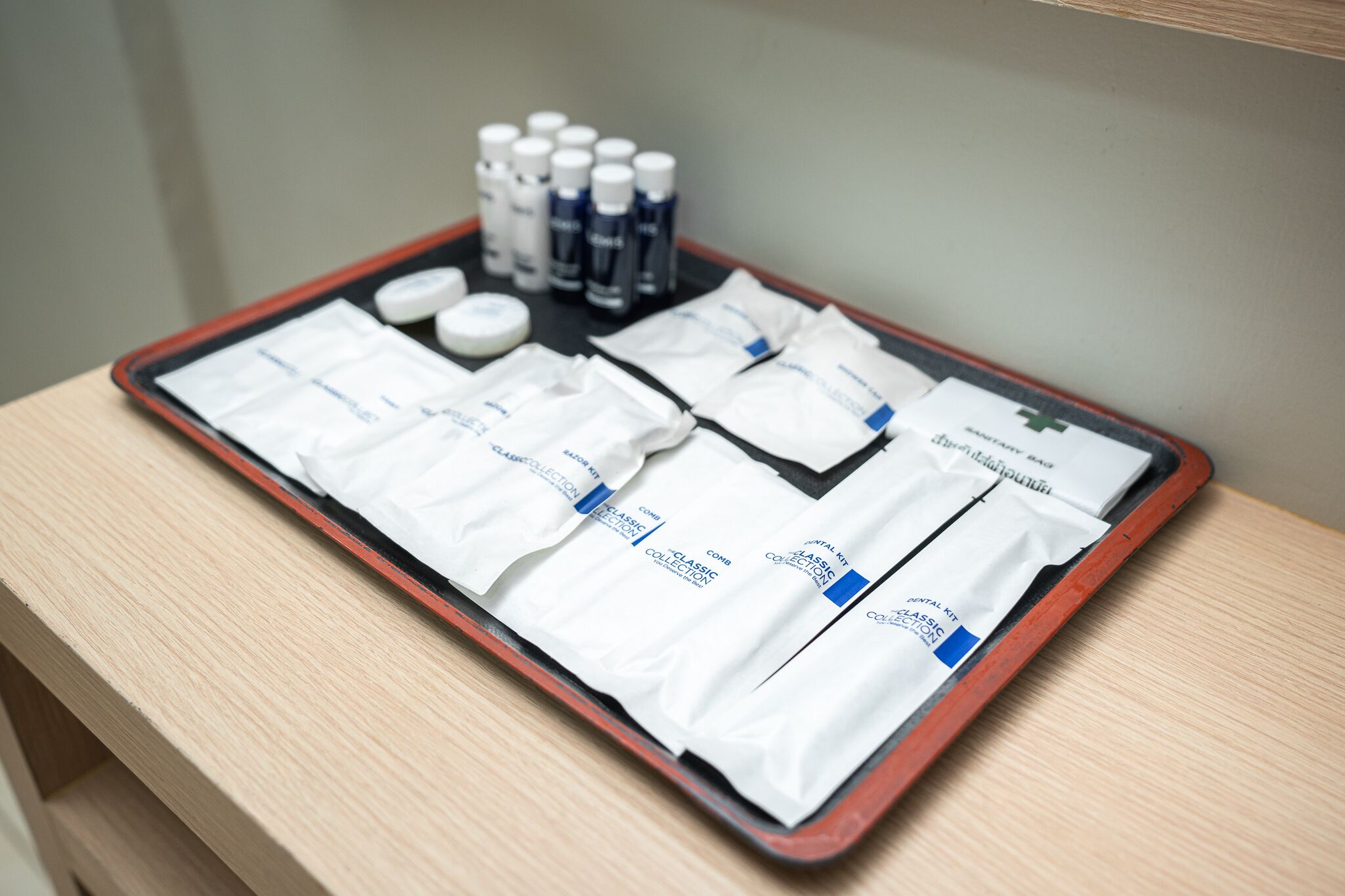 A tray with dental care items on a wooden table.