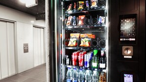 A vending machine with snacks, drinks, and a payment interface.