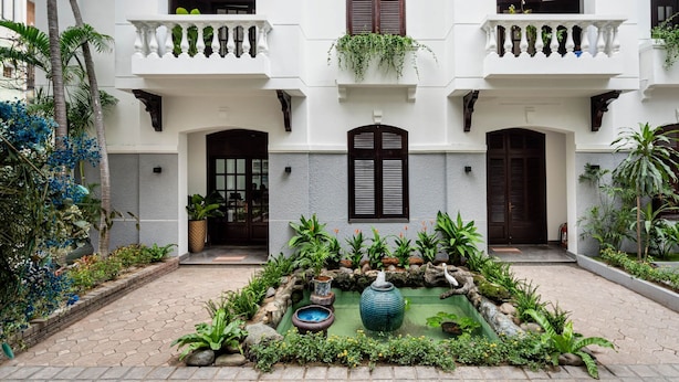 A courtyard with a central water feature, surrounded by plants and a stone pathway. - 5H Garden  (Ho Chi Minh City)