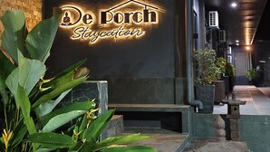 A building with a neon sign reading "De Porch St. Calocan". - DE PORCH (Bolinao)