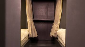 A narrow, enclosed room with bunk beds labeled D5, D6, D7, and D8.