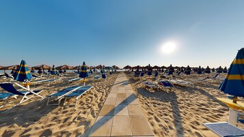 Playa privada, sillas reclinables de playa, sombrillas