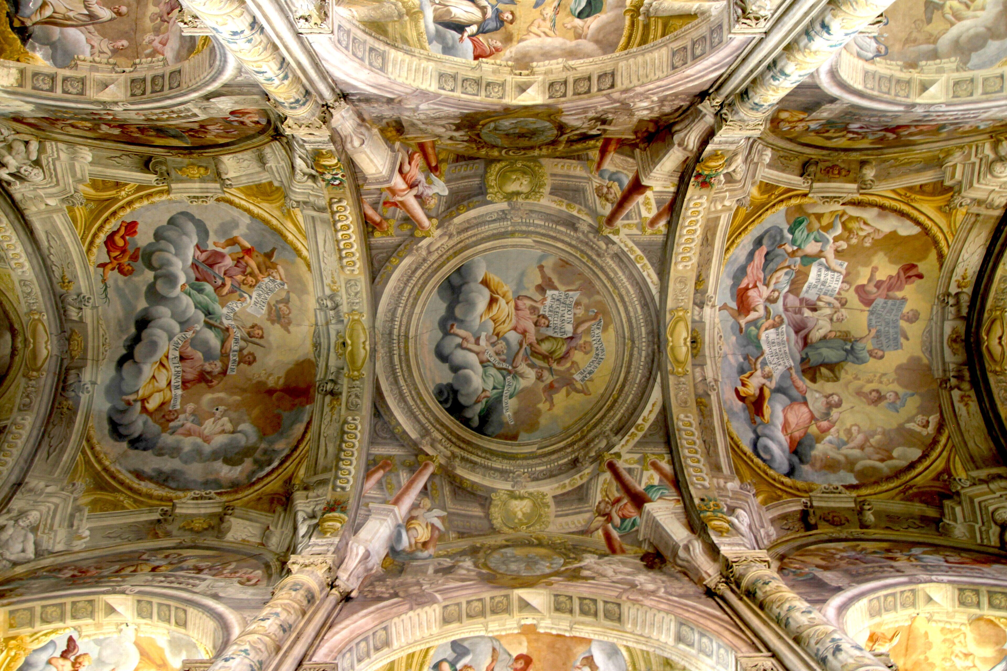 A grand hall with ornate ceiling frescoes and classical architectural elements.