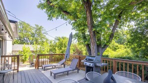 A deck with outdoor furniture, a grill, and a large tree providing shade. - Hot Tub House with BBQ Deck and Workspace (Centennial)