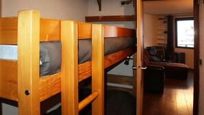 A bunk bed with a pull-up ladder, a sofa, and a window with curtains. - Bright studio for 4 in the heart of the resort with balcony (Les Orres)