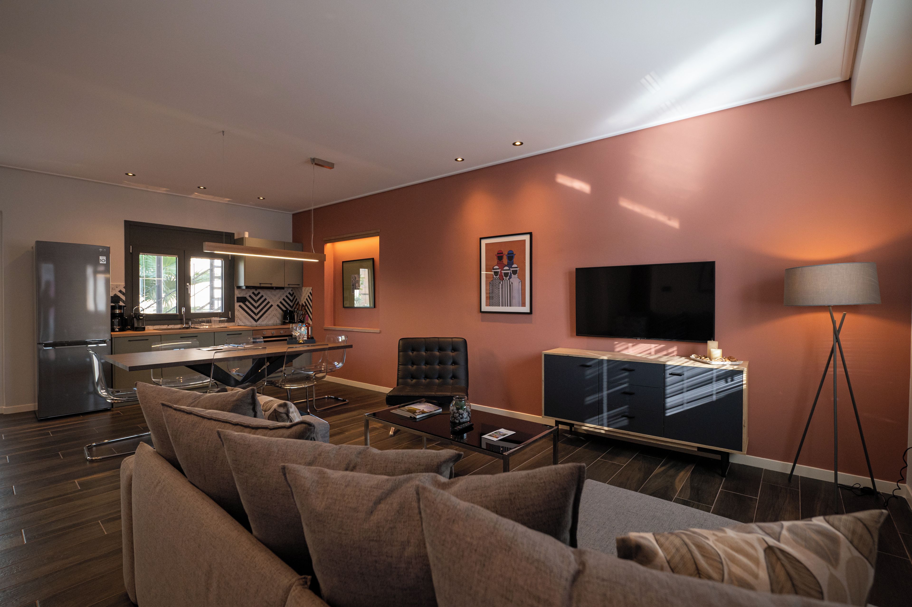Un salon moderne avec un canapé, une table basse et un téléviseur à écran plat.