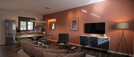 A modern living room with a sofa, coffee table, and a flat-screen TV.