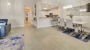A modern kitchen with white cabinets, a central island, and pendant lighting. - Beachside Bliss – Renovated Private Home in Sea Place Community with Resort (St. Augustine)