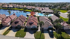 A residential area with houses, a swimming pool, and a lake. - Beachside Bliss – Renovated Private Home in Sea Place Community with Resort (St. Augustine)