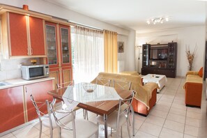 A compact living space with a kitchen, dining area, and a bedroom.