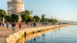 A historic tower with a circular base and a flat top, surrounded by a waterfront promenade with trees and lampposts. - Sanders Tower Centre - Serene Studio w/ Balcony 5799 (Thessaloniki)
