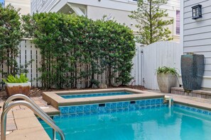 A swimming pool with a wooden deck and metal ladder, surrounded by a wooden fence and various potted plants. - Wave on Wave|Easy Beach Access|Private Pool|Gulf Views|Directly on 30A (Santa Rosa Beach)