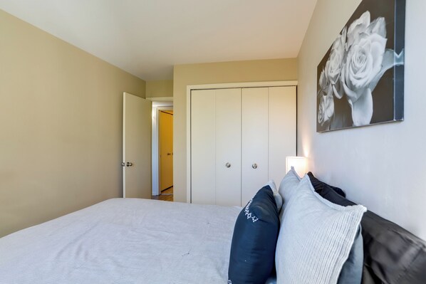 A bedroom with a bed, pillows, a wardrobe, and a wall-mounted painting. - Toledo Vacation Rental ~ 8 Mi to Downtown! (Toledo)