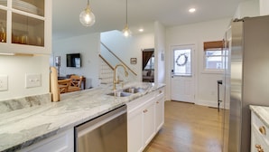 A kitchen with marble countertops, stainless steel appliances, and pendant lighting. - Charming Appomattox Home: Half-mi to Main Street! (Appomattox)