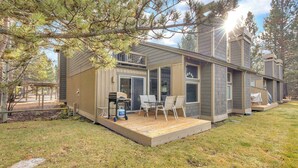 A modern two-story house with a deck, outdoor seating, and a grill area. - Wood fireplace, Wi-Fi access, guest perks, seasonal pool, tennis courts and hot tub access (Sunriver)