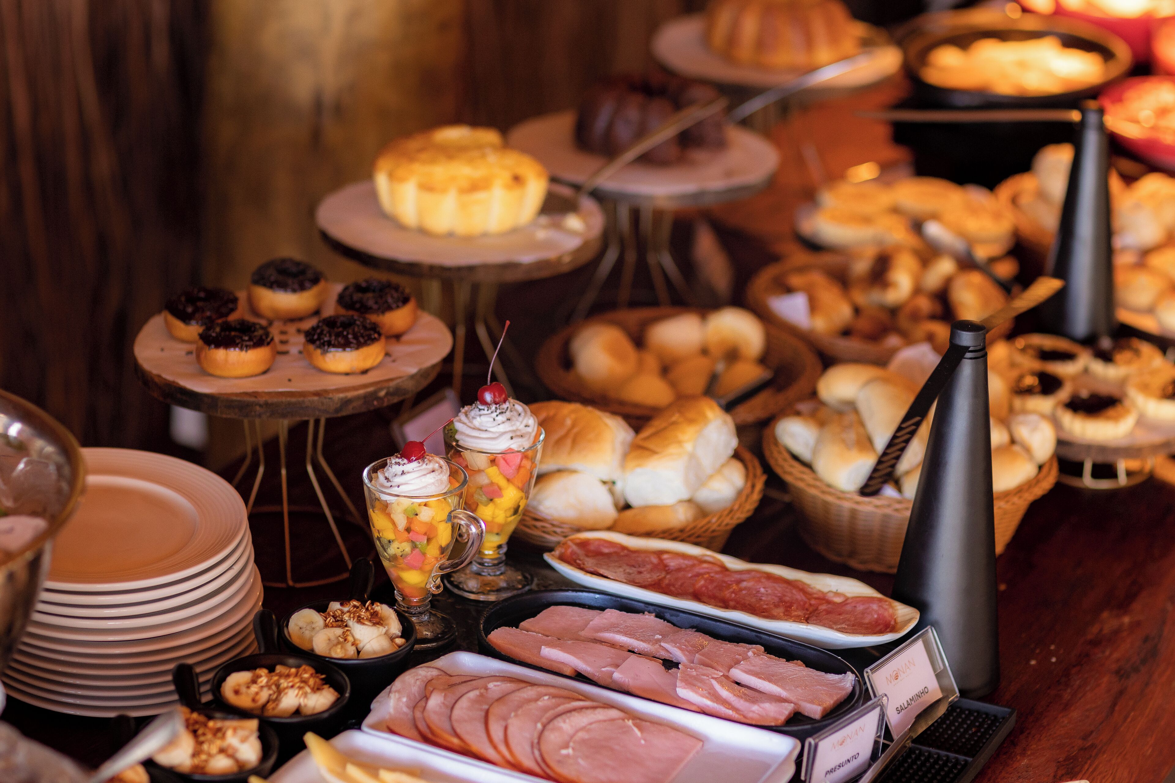 A buffet with various food items including pastries, meats, and desserts.