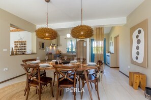 Enjoy meals in this elegant dining area with a round table for six and comfortable seating.