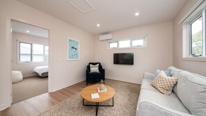 Relax in this inviting living room with a comfortable sofa, coffee table, and flat-screen TV.