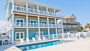 A multi-story building with a pool and outdoor seating. - Pa's Place, Almost Oceanfront House in Emerald Isle, NC! (Emerald Isle)