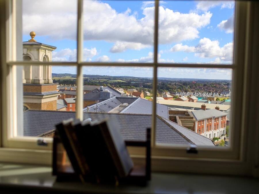A view through a window with a book on a windowsill.
